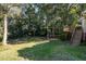 Lush backyard featuring a wooden deck and mature trees, providing a private outdoor space at 1224 Manchester Dr, Raleigh, NC 27609