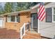 Charming brick front entrance with stylish door and American flag accent at 1224 Manchester Dr, Raleigh, NC 27609
