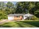 Charming ranch-style home with a brick facade, attached garage, and landscaped front yard at 1224 Manchester Dr, Raleigh, NC 27609