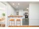 Kitchen view showcasing bar seating and modern appliances, creating a functional and stylish space at 1224 Manchester Dr, Raleigh, NC 27609