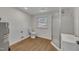 Updated bathroom features a shower, toilet, and sink with laminate flooring throughout at 1403 Fairground Road Rd, Dunn, NC 28334