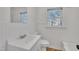A well-lit bathroom features a toilet, sink, and stylish beadboard paneling at 1403 Fairground Road Rd, Dunn, NC 28334