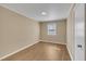 Bright bedroom featuring light colored walls, wood flooring, and a window at 1403 Fairground Road Rd, Dunn, NC 28334
