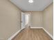 Bedroom with an open doorway and neutral walls with laminate flooring at 1403 Fairground Road Rd, Dunn, NC 28334
