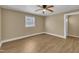 Bright bedroom featuring light colored walls, wood flooring, and a window at 1403 Fairground Road Rd, Dunn, NC 28334