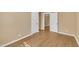 A spacious bedroom with light walls, wood flooring, and multiple doorways at 1403 Fairground Road Rd, Dunn, NC 28334