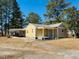 Charming single-story home with a welcoming front porch and attached carport at 1403 Fairground Road Rd, Dunn, NC 28334