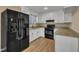 Well-lit kitchen features stainless steel appliances, granite countertops, and ample cabinet space at 1403 Fairground Road Rd, Dunn, NC 28334