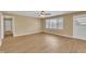 Open living room features natural light from the window and laminate flooring throughout at 1403 Fairground Road Rd, Dunn, NC 28334