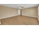 Bright living room featuring a ceiling fan and neutral walls with laminate flooring throughout at 1403 Fairground Road Rd, Dunn, NC 28334