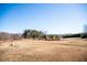 A wide-open lot is surrounded by trees on a sunny day, full of potential for future owners to create their paradise at 159 Valhalla Dr, Timberlake, NC 27583