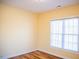 Bright bedroom featuring wood floors, yellow walls, and a window with natural light at 159 Valhalla Dr, Timberlake, NC 27583