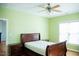 Bright bedroom features hardwood floors, ceiling fan, large window and neutral paint at 159 Valhalla Dr, Timberlake, NC 27583