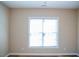 A bright and airy bedroom features a large window, neutral walls, and hardwood floors at 159 Valhalla Dr, Timberlake, NC 27583