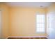 Bedroom featuring a window providing natural light, yellow walls, and hardwood floors at 159 Valhalla Dr, Timberlake, NC 27583