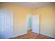 Bedroom features hardwood floors and yellow walls, with an open door to a hallway at 159 Valhalla Dr, Timberlake, NC 27583