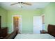 Bright bedroom features hardwood floors, ceiling fan, and bathroom access at 159 Valhalla Dr, Timberlake, NC 27583
