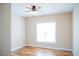 A cozy bedroom featuring hardwood floors, a ceiling fan, and a bright window at 159 Valhalla Dr, Timberlake, NC 27583