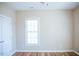 Neutral bedroom featuring hardwood floors, a bright window, and a white door at 159 Valhalla Dr, Timberlake, NC 27583