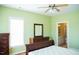 Bright bedroom features hardwood floors, ceiling fan, large window and access to bathroom at 159 Valhalla Dr, Timberlake, NC 27583