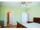 Bright bedroom features hardwood floors, neutral paint, and bathroom and kitchen access at 159 Valhalla Dr, Timberlake, NC 27583