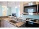 Kitchen featuring granite countertops and stainless steel appliances with views to the living area at 159 Valhalla Dr, Timberlake, NC 27583