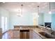 Kitchen with stainless steel dishwasher and sink overlooking the dining area and living room at 159 Valhalla Dr, Timberlake, NC 27583