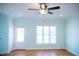 Bright living room with hardwood floors, a ceiling fan, and a door to the backyard at 159 Valhalla Dr, Timberlake, NC 27583