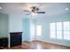 Bright living room with hardwood floors, fireplace, ceiling fan, and a door to the backyard at 159 Valhalla Dr, Timberlake, NC 27583