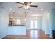 Open-concept living and dining area featuring hardwood floors, a ceiling fan, and plenty of natural light at 159 Valhalla Dr, Timberlake, NC 27583