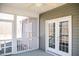Covered porch featuring white railing and view of the home's siding and double doors at 159 Valhalla Dr, Timberlake, NC 27583