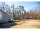A charming single-story home featuring a screened porch and a spacious backyard surrounded by trees at 159 Valhalla Dr, Timberlake, NC 27583