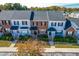Aerial view of multiple townhomes with manicured lawns, landscaping and sidewalks at 1707 Stroll Cir, Fuquay Varina, NC 27526