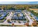 Aerial view of a neighborhood with townhomes, parking and colorful fall foliage at 1707 Stroll Cir, Fuquay Varina, NC 27526