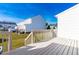 Backyard deck with stairs going into the yard of a two story townhouse in a suburban neighborhood at 1707 Stroll Cir, Fuquay Varina, NC 27526