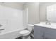 Bathroom with a gray vanity, modern fixtures, white bathtub and tile flooring at 1707 Stroll Cir, Fuquay Varina, NC 27526