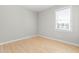 This is a bedroom featuring light walls, base trim, and a window that allows natural light to fill the space at 1707 Stroll Cir, Fuquay Varina, NC 27526
