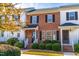 Charming brick townhouse with black shutters and a well-manicured front yard at 1707 Stroll Cir, Fuquay Varina, NC 27526