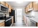 Modern kitchen with stainless steel appliances and wood cabinets at 1707 Stroll Cir, Fuquay Varina, NC 27526