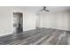 Spacious living room with hardwood floors, ceiling fan and access to the kitchen at 1707 Stroll Cir, Fuquay Varina, NC 27526
