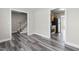 Open-concept living room with hardwood floors and views into the kitchen and hall at 1707 Stroll Cir, Fuquay Varina, NC 27526