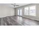 Airy living room with hardwood floors, ceiling fan, and sliding glass doors at 1707 Stroll Cir, Fuquay Varina, NC 27526
