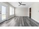 Bright living room with hardwood floors, ceiling fan, and access to the back deck at 1707 Stroll Cir, Fuquay Varina, NC 27526