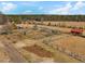 Aerial view of sprawling property featuring large outbuildings, fenced yard, and surrounded by mature trees at 1834 Dewitt Smith Rd, Pittsboro, NC 27312