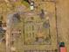 Bird's eye view of the property displaying garden, sheds, and a well-maintained lawn at 1834 Dewitt Smith Rd, Pittsboro, NC 27312