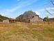 Exterior view of a horse barn and outbuilding featuring traditional architecture and paddock at 1834 Dewitt Smith Rd, Pittsboro, NC 27312