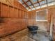 Interior view of a horse stall featuring wood construction, concrete flooring, and workbench at 1834 Dewitt Smith Rd, Pittsboro, NC 27312