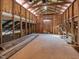 Interior view of a storage area in the barn featuring wood framing, exposed beams, and open storage at 1834 Dewitt Smith Rd, Pittsboro, NC 27312