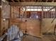 Interior view of horse stall with wood framing and half door with latch, including an Adirondack chair at 1834 Dewitt Smith Rd, Pittsboro, NC 27312