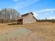 Exterior view of a horse barn featuring traditional architecture, with a small porch at 1834 Dewitt Smith Rd, Pittsboro, NC 27312